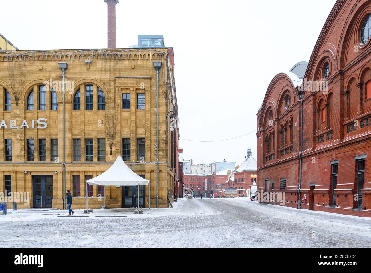 Inner plaza covered with snow between group of renovated brick