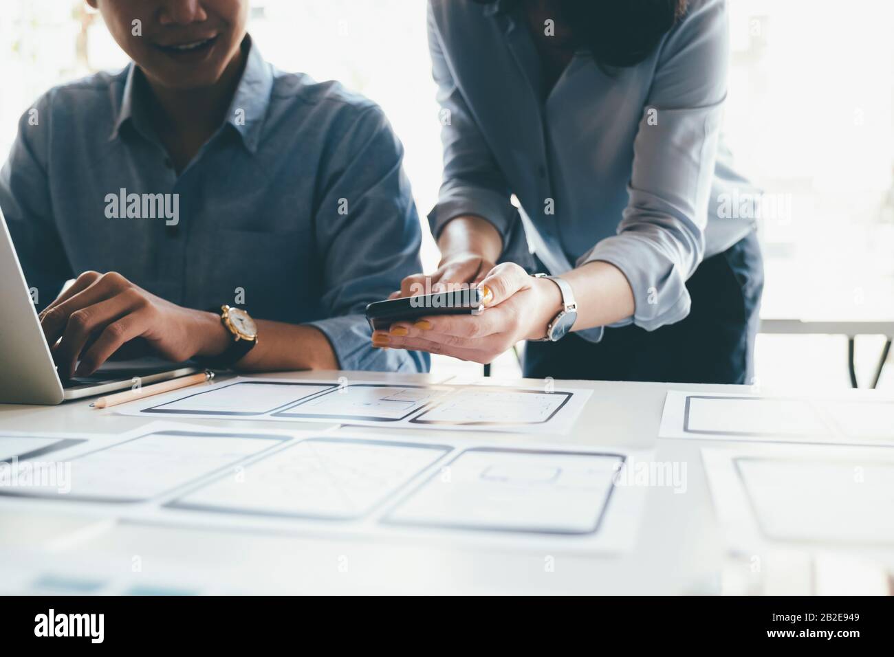 Programmer and UX UI designer working in a software development and coding technologies. Mobile and website design and programing development technolo Stock Photo
