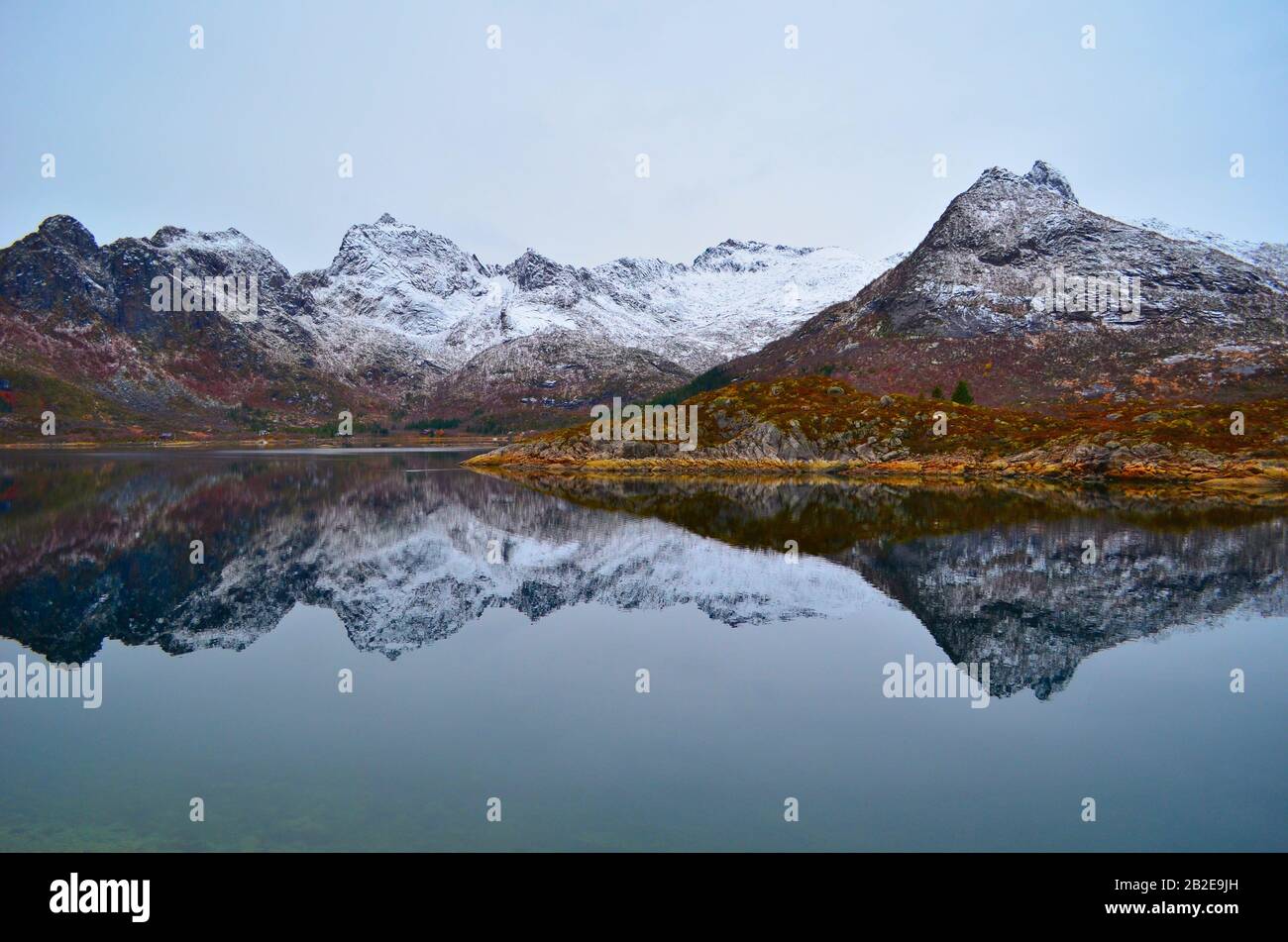 Snowy mountains are perfectly reflected in the mountain lake Stock Photo