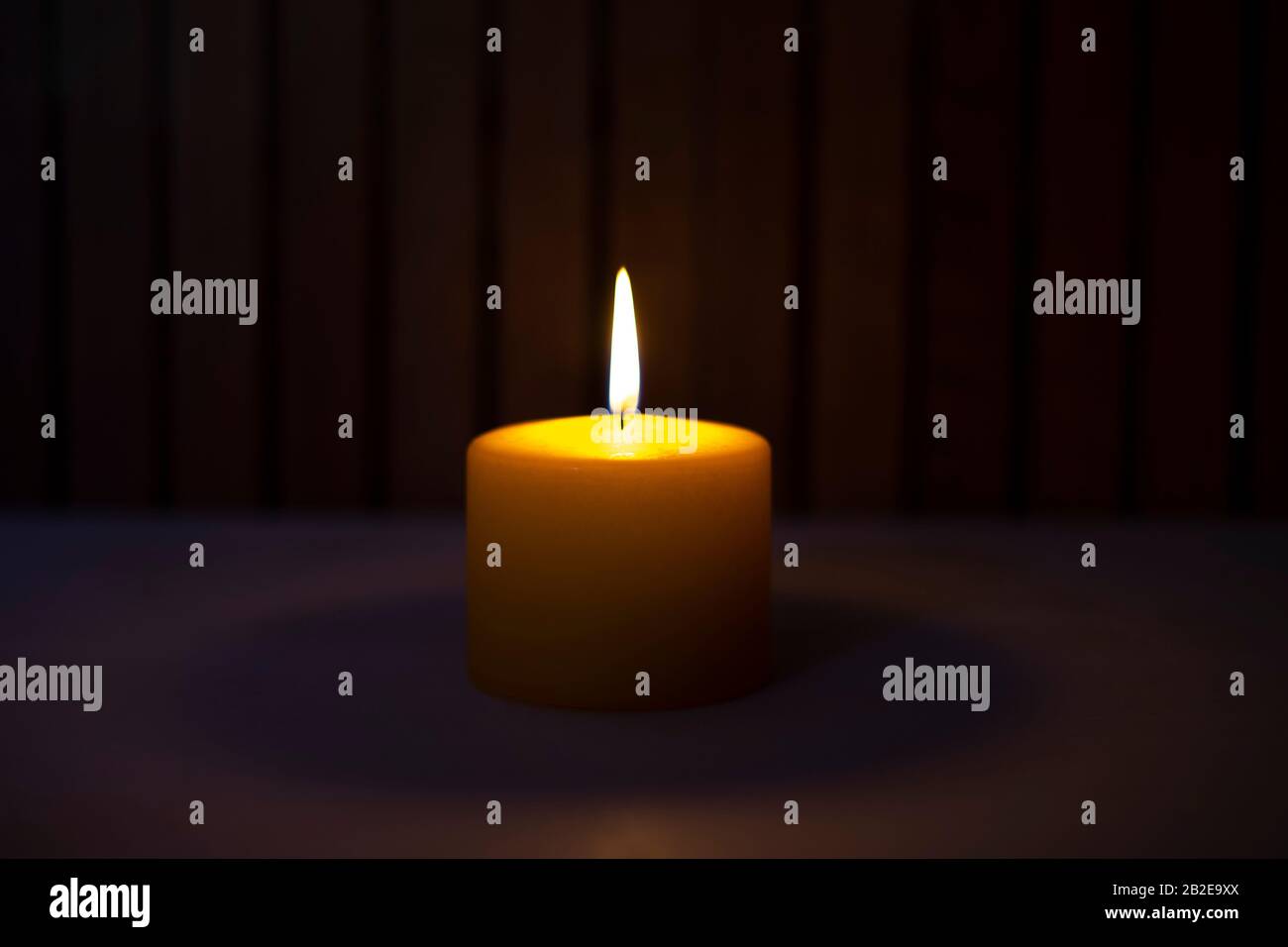 Yellow candle lit in the dark. Candle concept Stock Photo Alamy