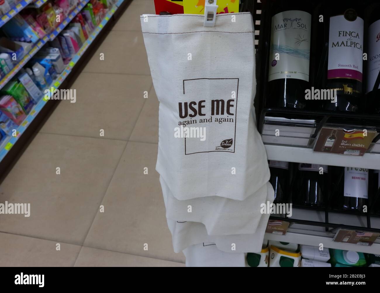 Bangkok, Thailand- March 1 2020: Selective focus on phrase use me again and again on cloth bag  hanging by clip in a row in 7-eleven convenience store Stock Photo