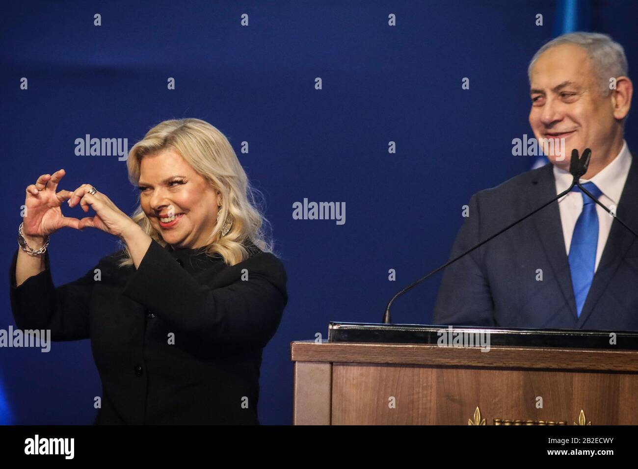 Tel Aviv, Israel. 03rd Mar, 2020. Israeli Prime Minister and Chairman of the Likud Party, Benjamin Netanyahu, smiles as his wife Sara gestures while addressing supporters following early exit polls. Credit: Ilia Yefimovich/dpa/Alamy Live News Stock Photo