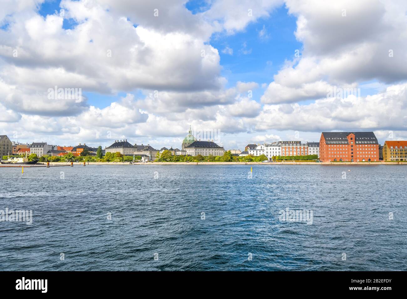 View across the water from Holmen Island of the Amalienborg castle and the Marble or Frederik's Church in Copenhagen Denmark. Stock Photo