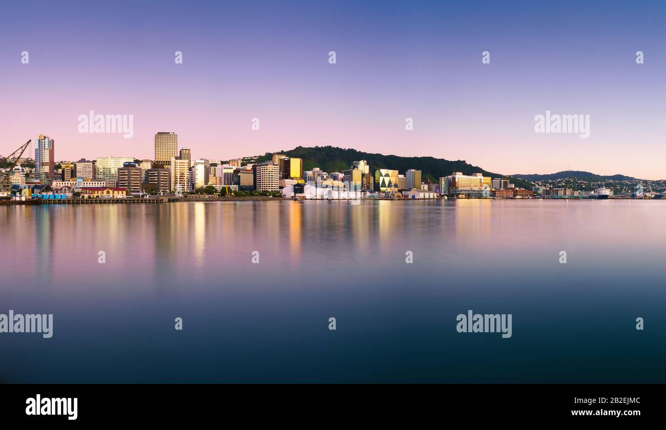 Wellington, New Zealand city buildings and skyline reflected in the harbour at sunrise on a perfect summer morning. Wellington is the capital of NZ. Stock Photo
