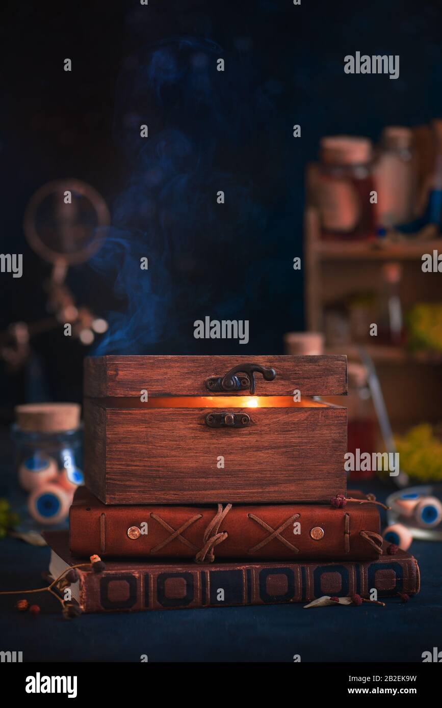 Wooden box containing fire, magical still life, trapped star, witch workplace with copy space Stock Photo