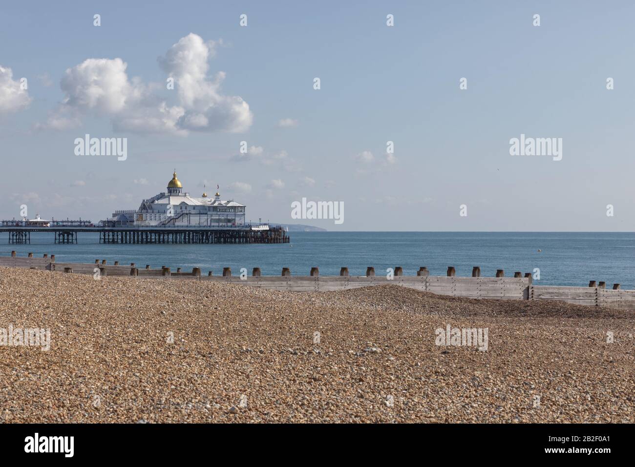 pebbled beach with Eastbourne pier in the background Stock Photo