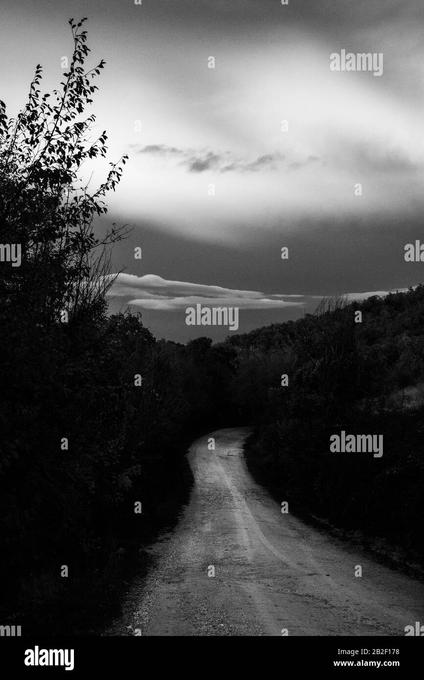A mountain road below clouds at sunset after a storm Stock Photo - Alamy