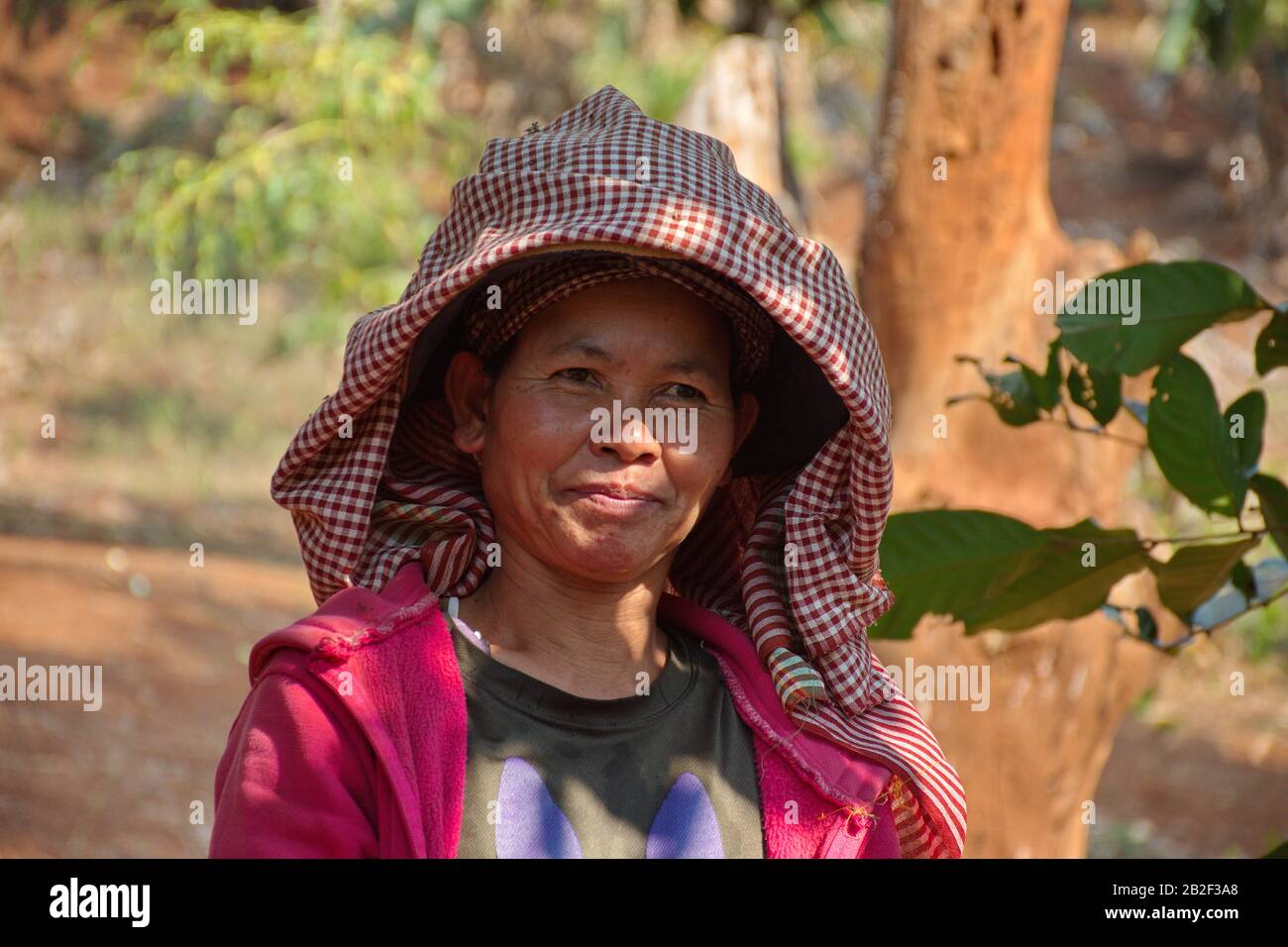 Portrait of Cambodian woman with hat in nature Stock Photo