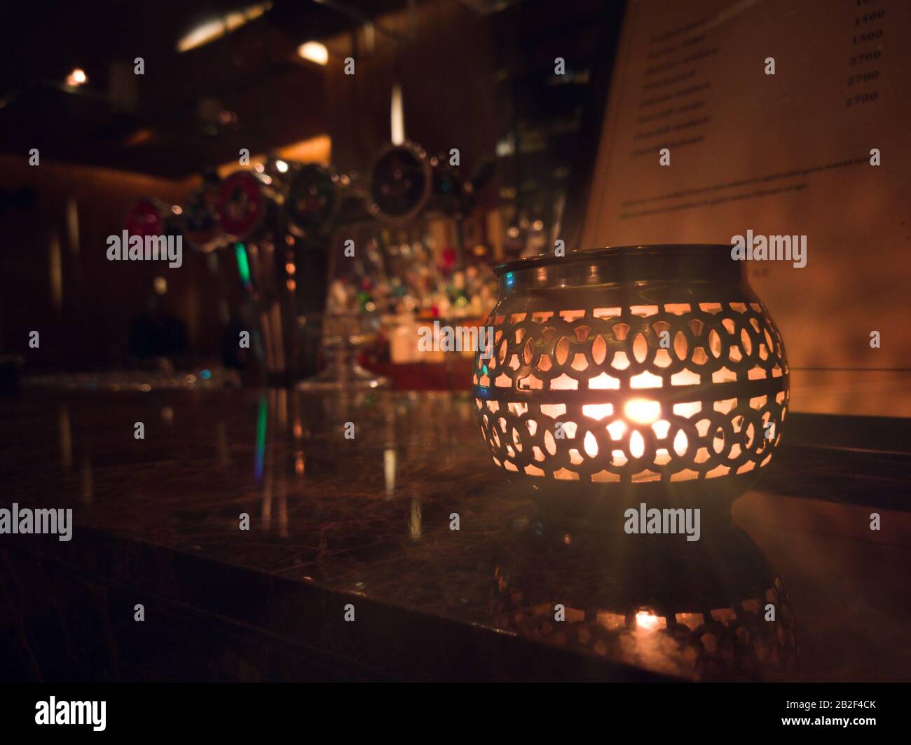 Beautifully lit lamp on a decorated table Stock Photo