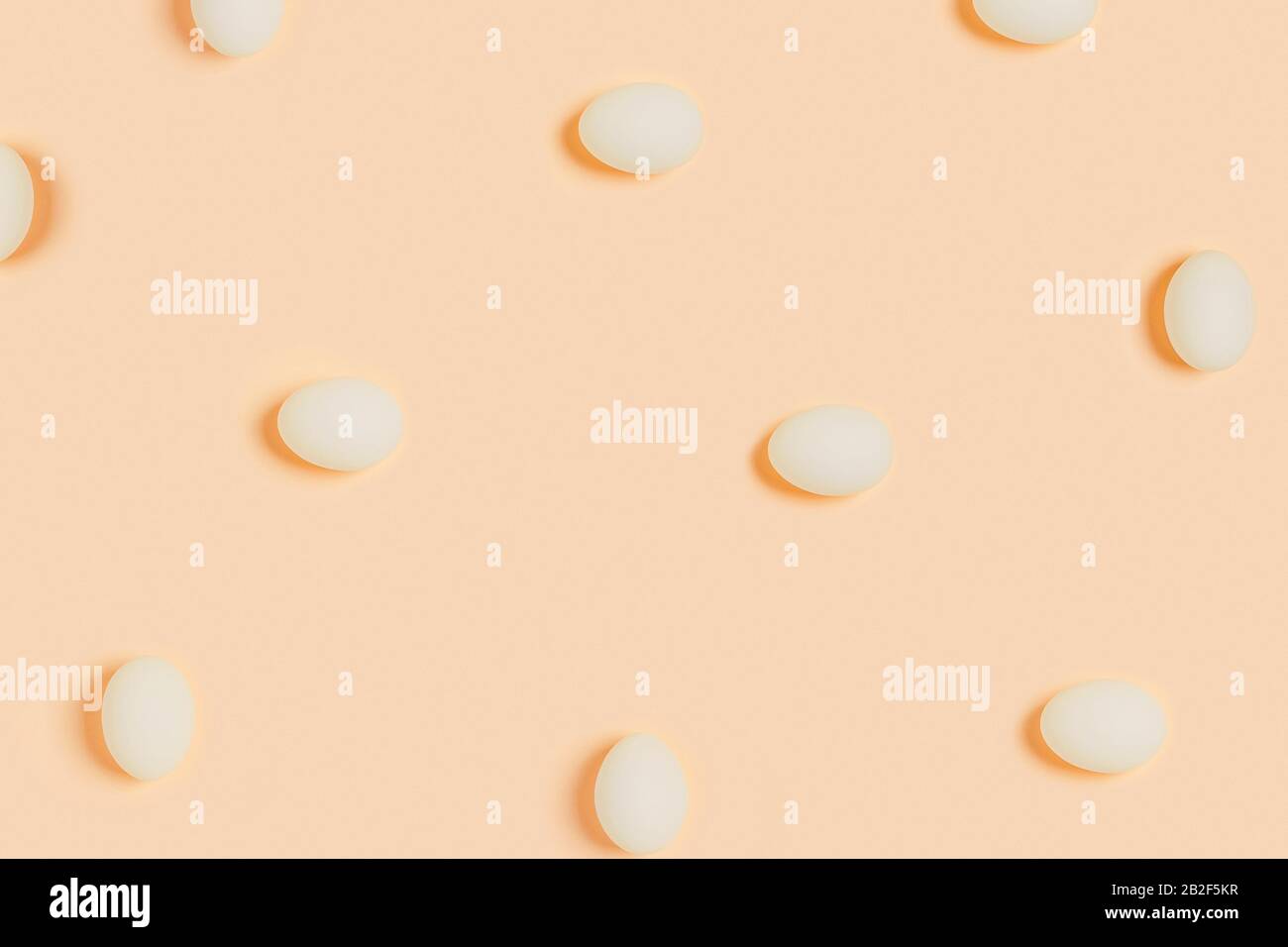 Happy Easter. White eggs on yellow background. Flat lay, top view, copy space. Stock Photo