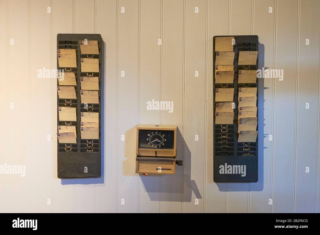 Time clock and punch cards mounted on a wall. At the National Wool