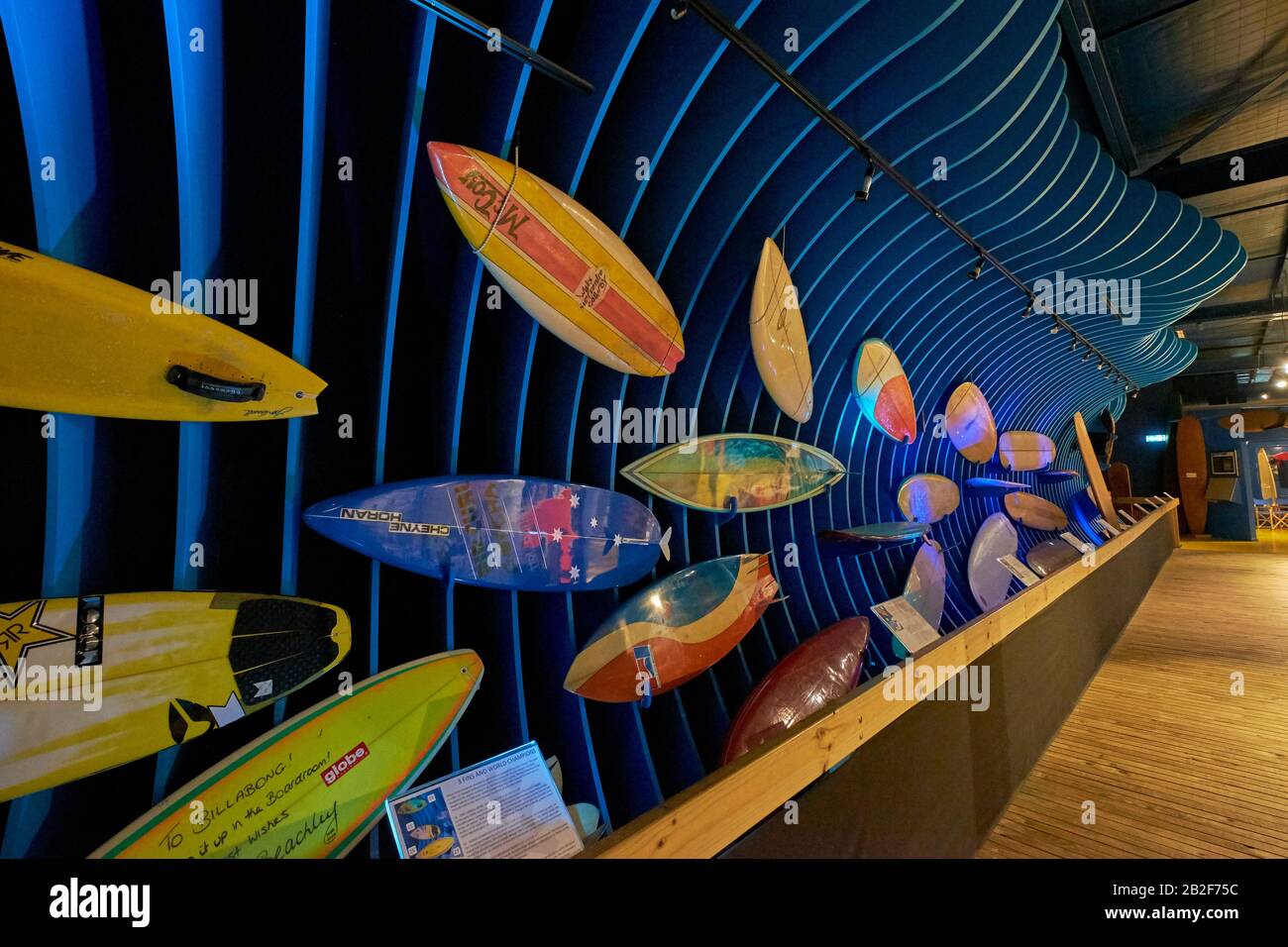 A long display of various surfboards. At the Surf World Museum in Torquay, Great Ocean Road