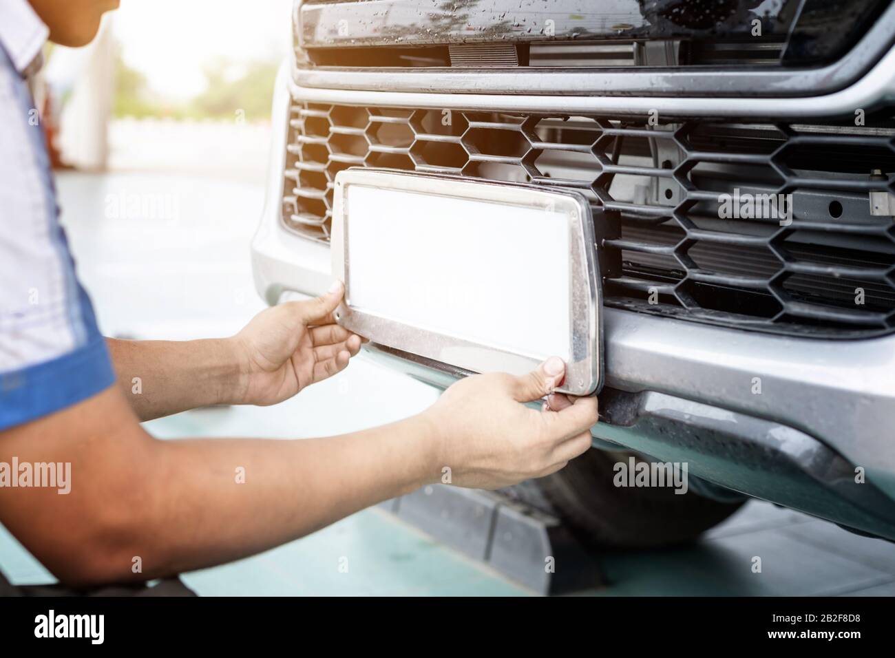 Technician changing Thailand car plate number in service center Stock Photo