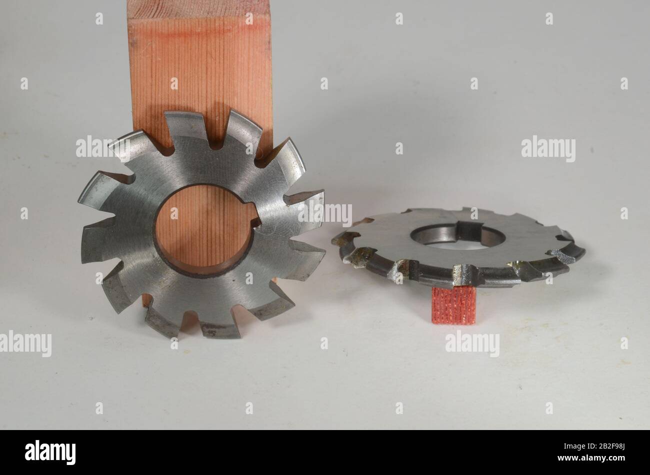 Milling tools for making teeth on gear wheels, two alike speciments, one in side view and one in profile view Stock Photo