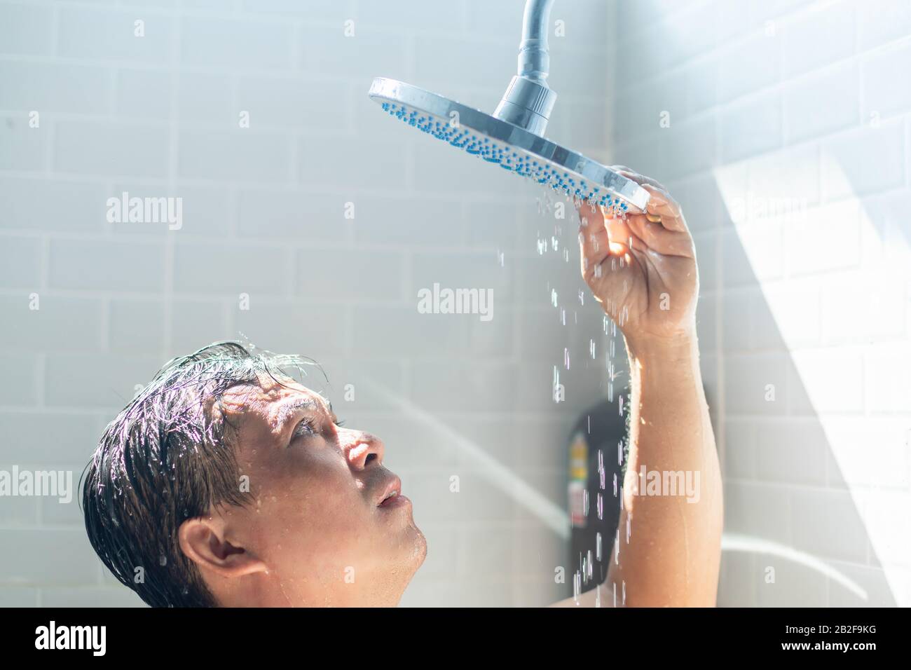 Worried Asian man take a shower in the bathroom and water was turned off. He looking to shower