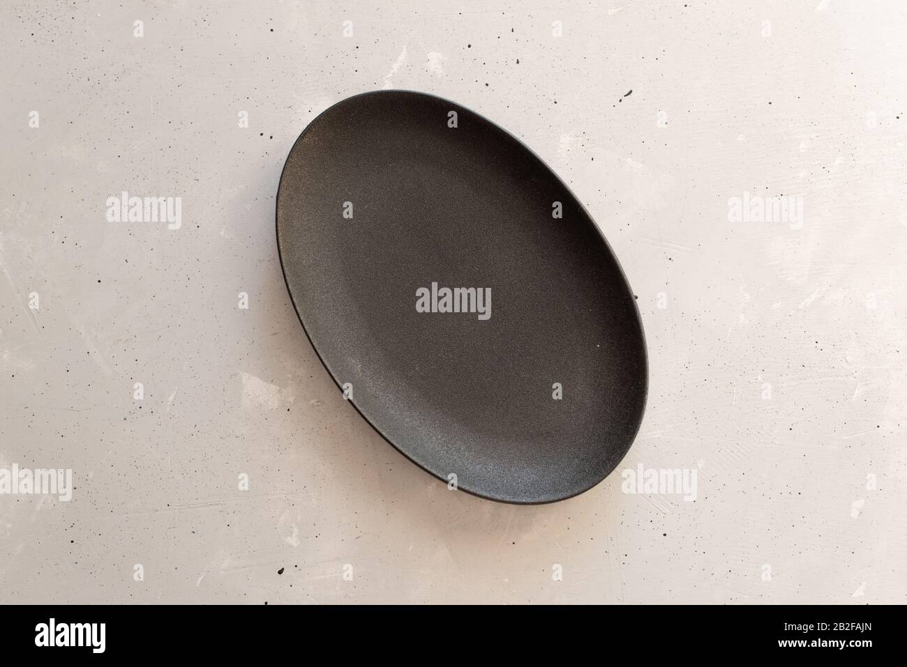 Empty plate on grey wooden table. Stock Photo
