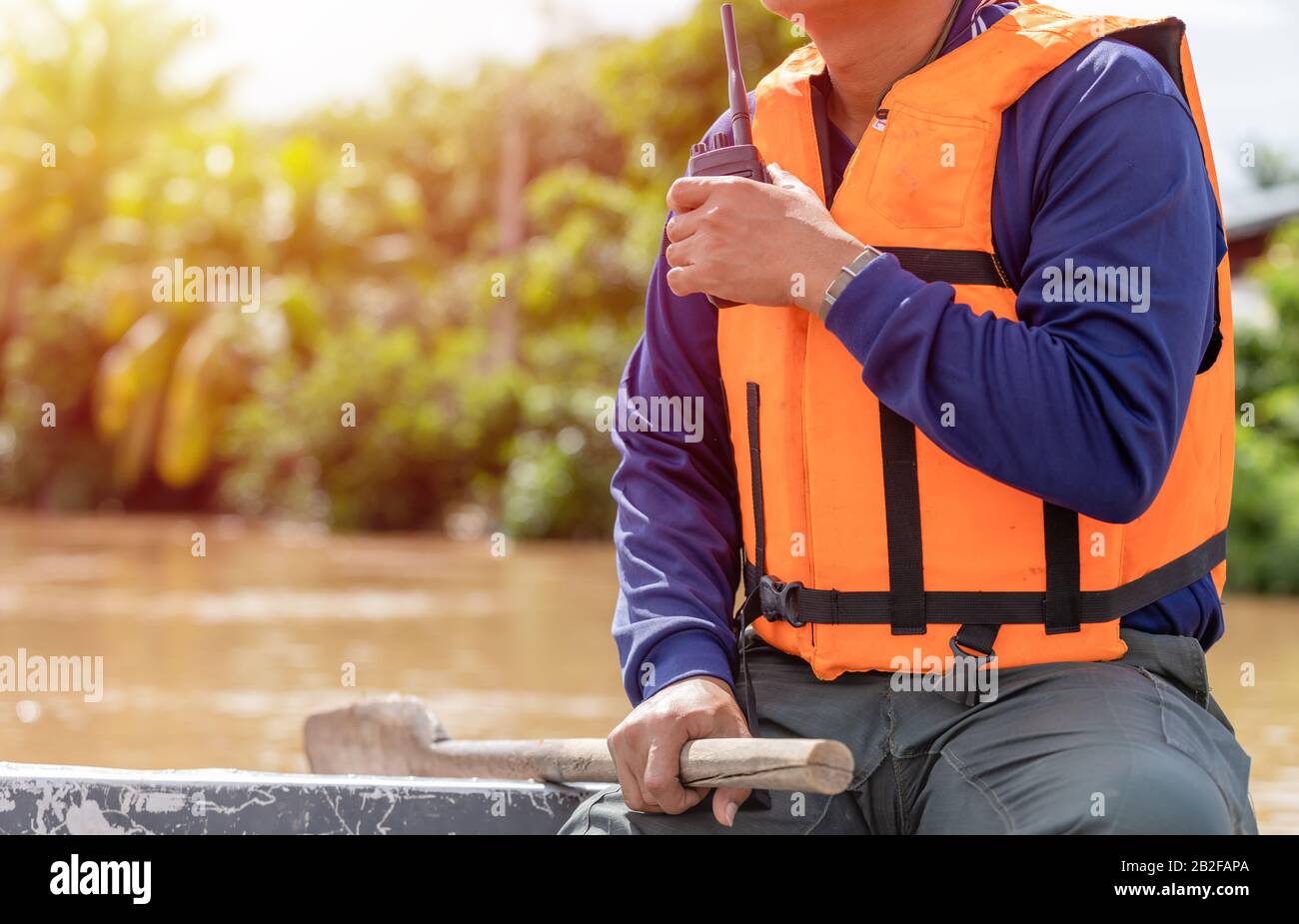A man using walkie talkie on the boat a while helping the victim of  flooding in Thailand Stock Photo - Alamy
