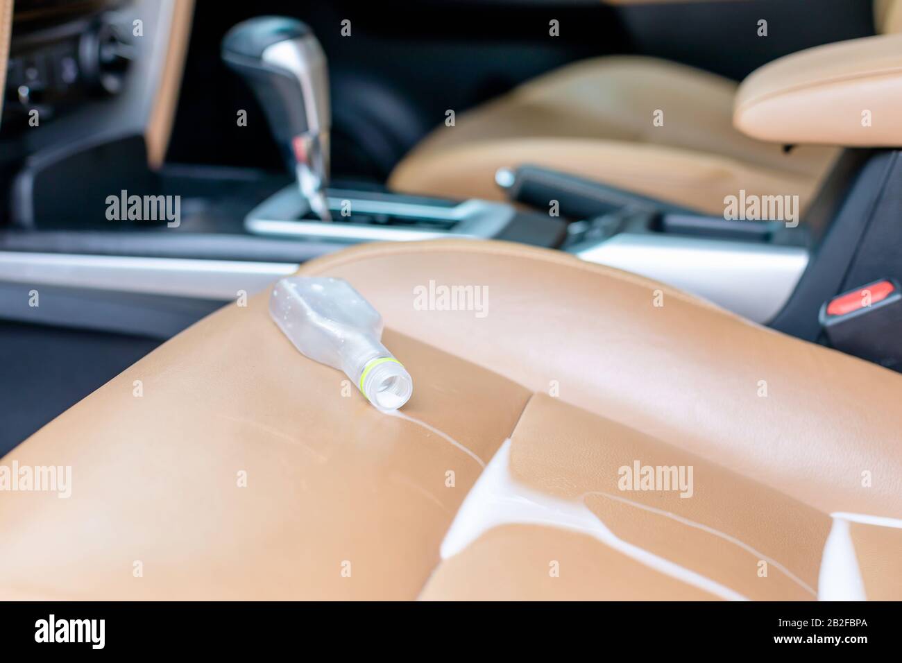 White liquid of medicine spill on the seat inside of modern car. Car