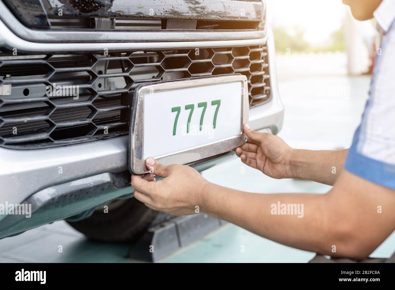 Technician changing Thailand car plate number in service center Stock Photo