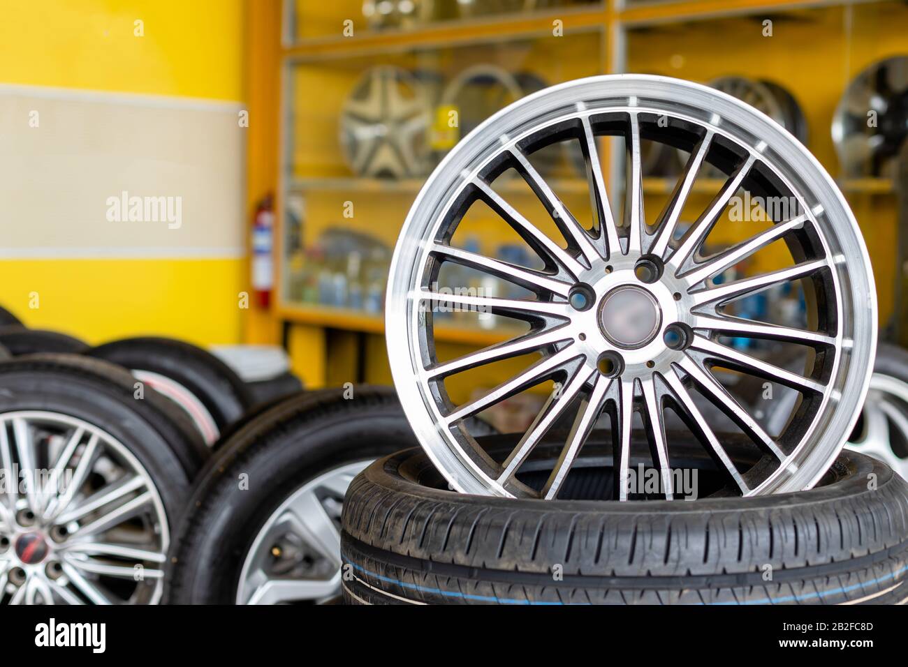 New silver mag wheel. Magnesium alloy car wheels and pneumatic tires in store or service center Stock Photo