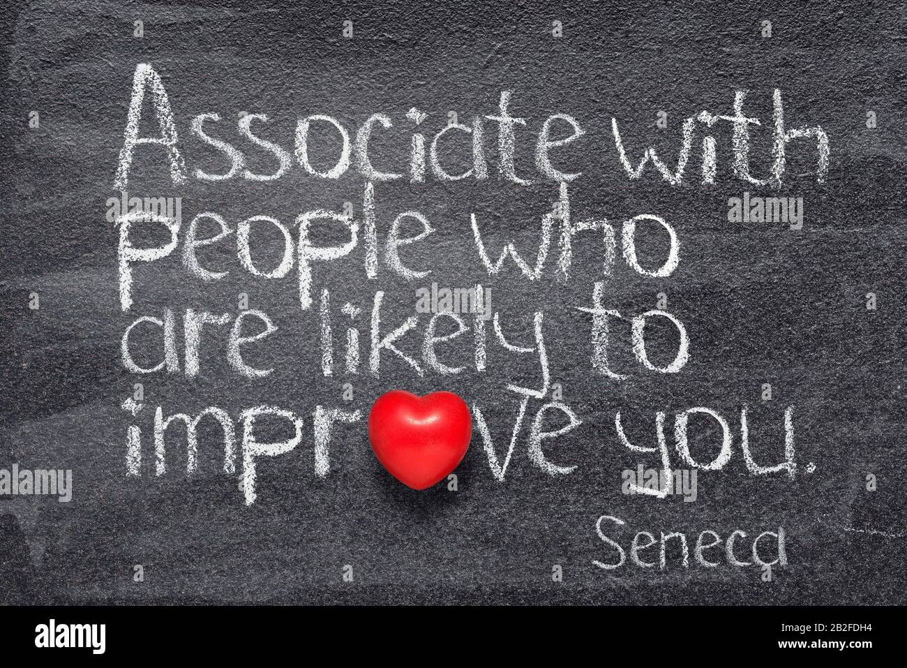 Associate with people who are likely to improve you - quote of ancient Roman philosopher Seneca written on chalkboard Stock Photo