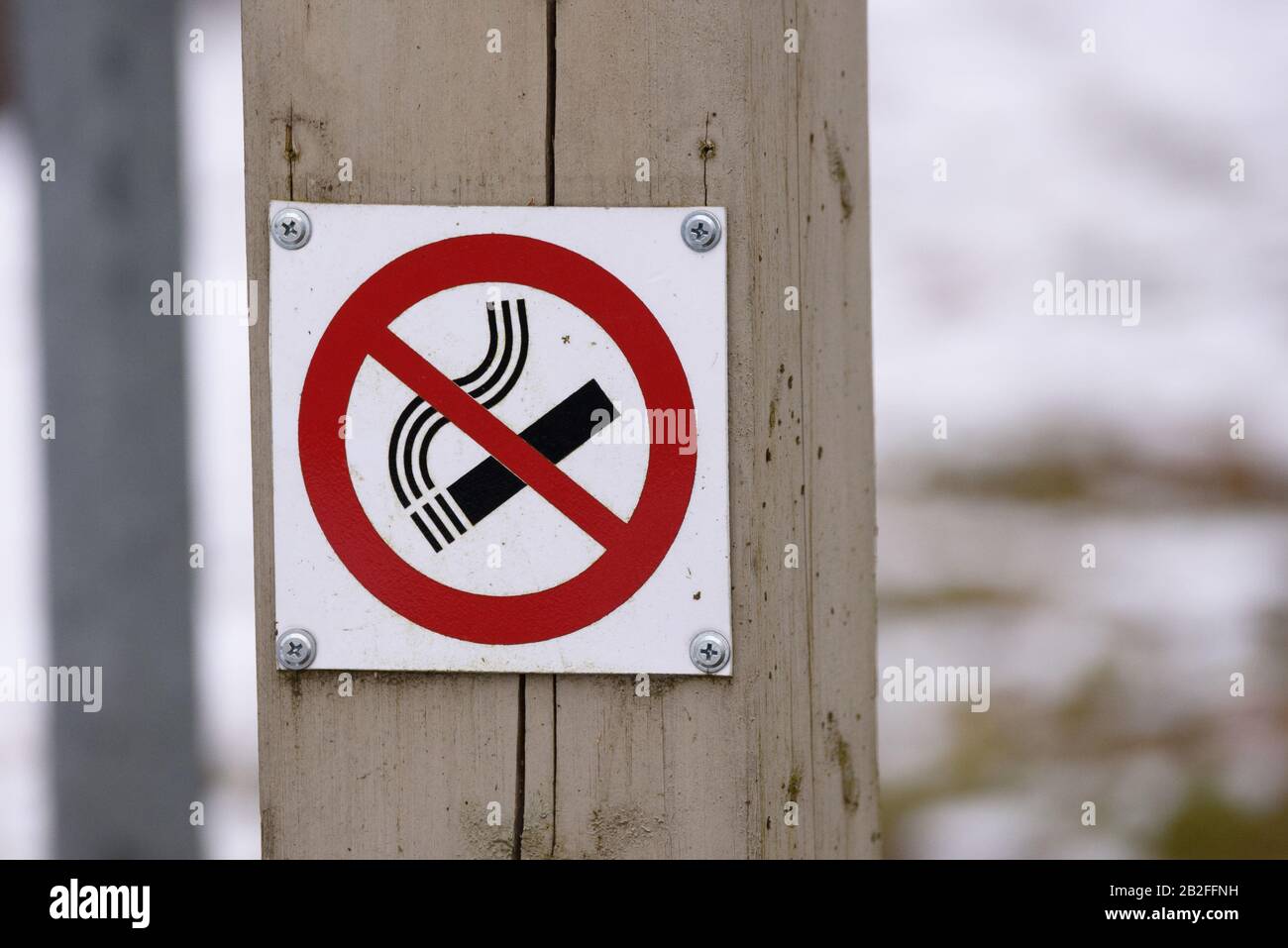 TALSI, LATVIA. 30h March 2018. No smoking sign on wooden pole at public place in city. Stock Photo