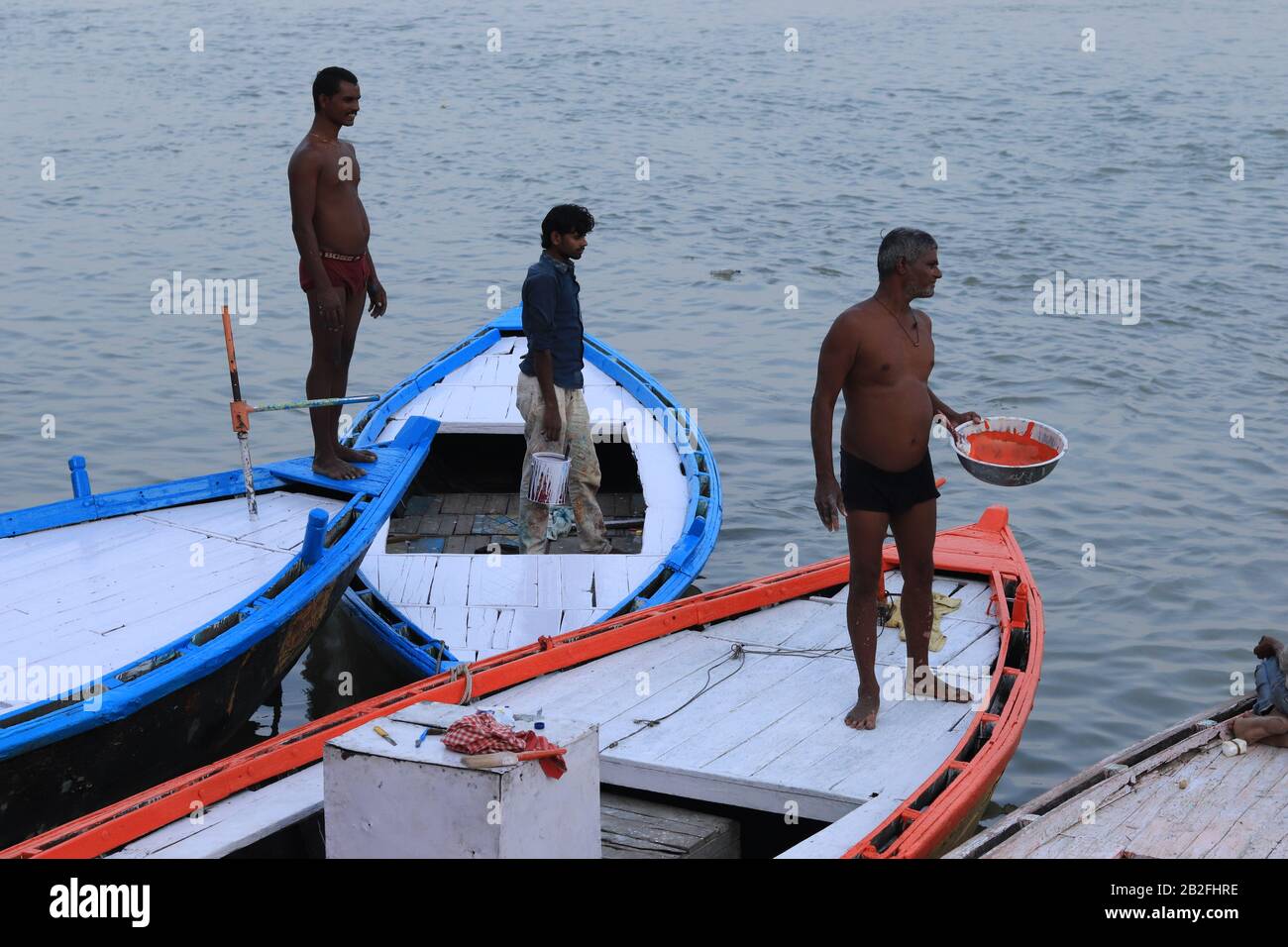 Three men on the their boats at Ganga River Stock Photo