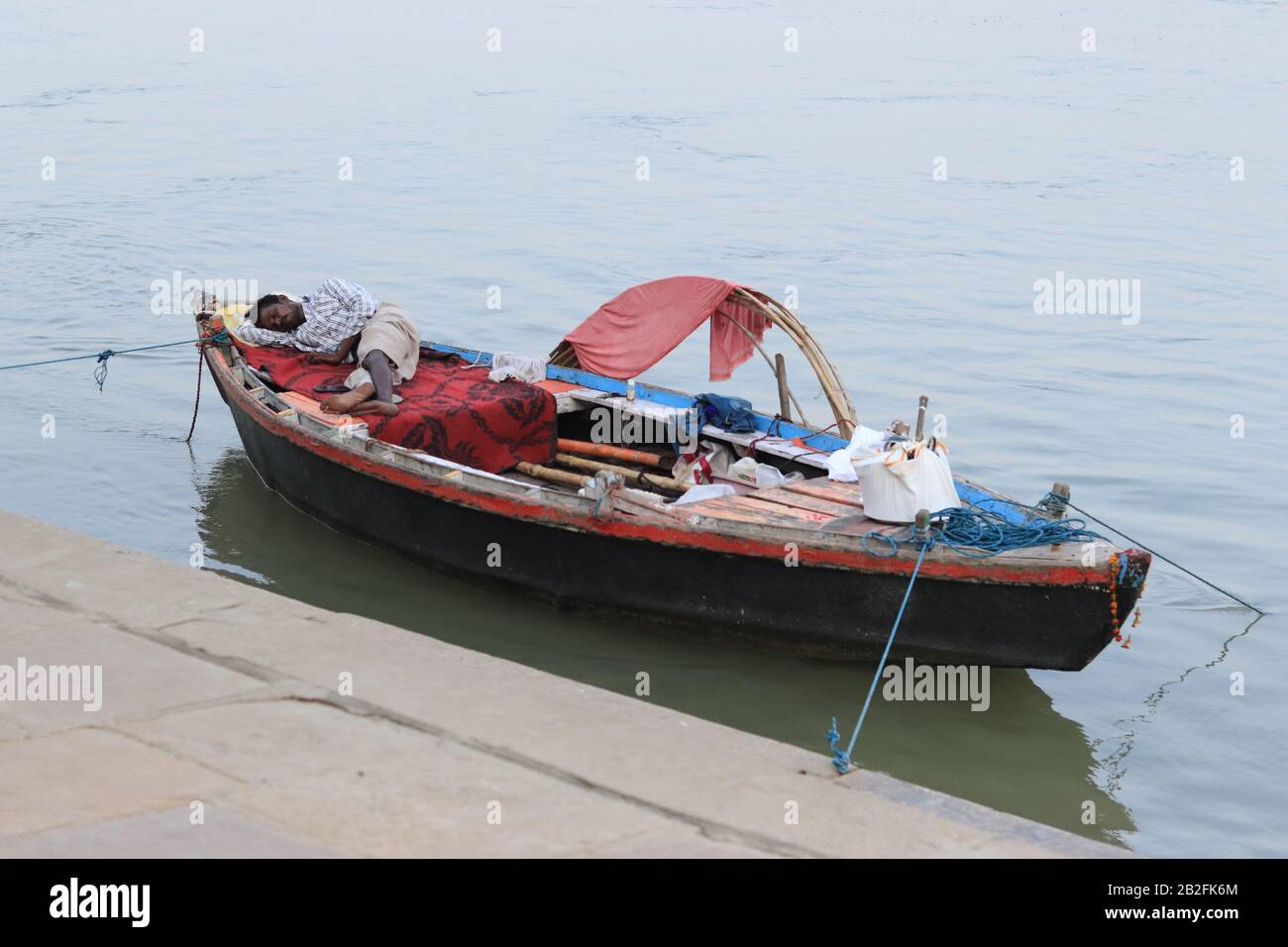 Life on the boat of Indian man in Varanasi Stock Photo