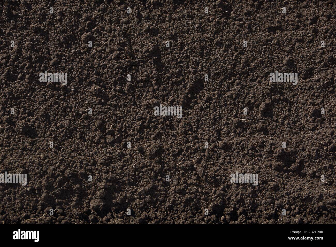 texture of fertile soil the background is a deep brown color. for