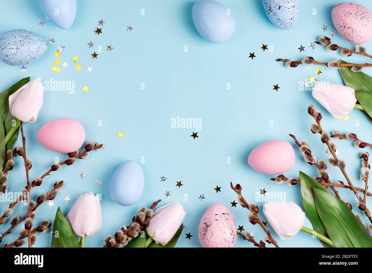 Festive frame with Easter handcraft painted eggs and tulips flowers ...