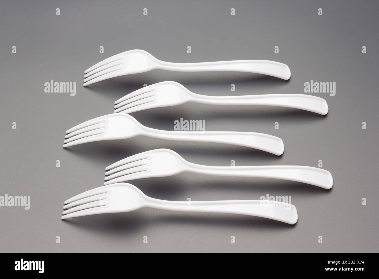 Forks of white color and constructed with recyclable plastic material, to prick Picnic food