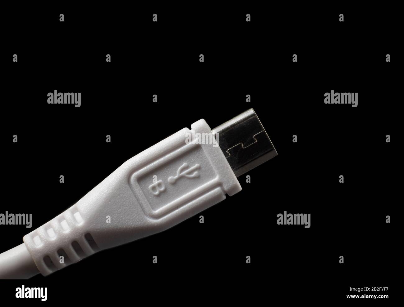Micro USB type B plug with logo. Male connector isolated on black. Stock Photo
