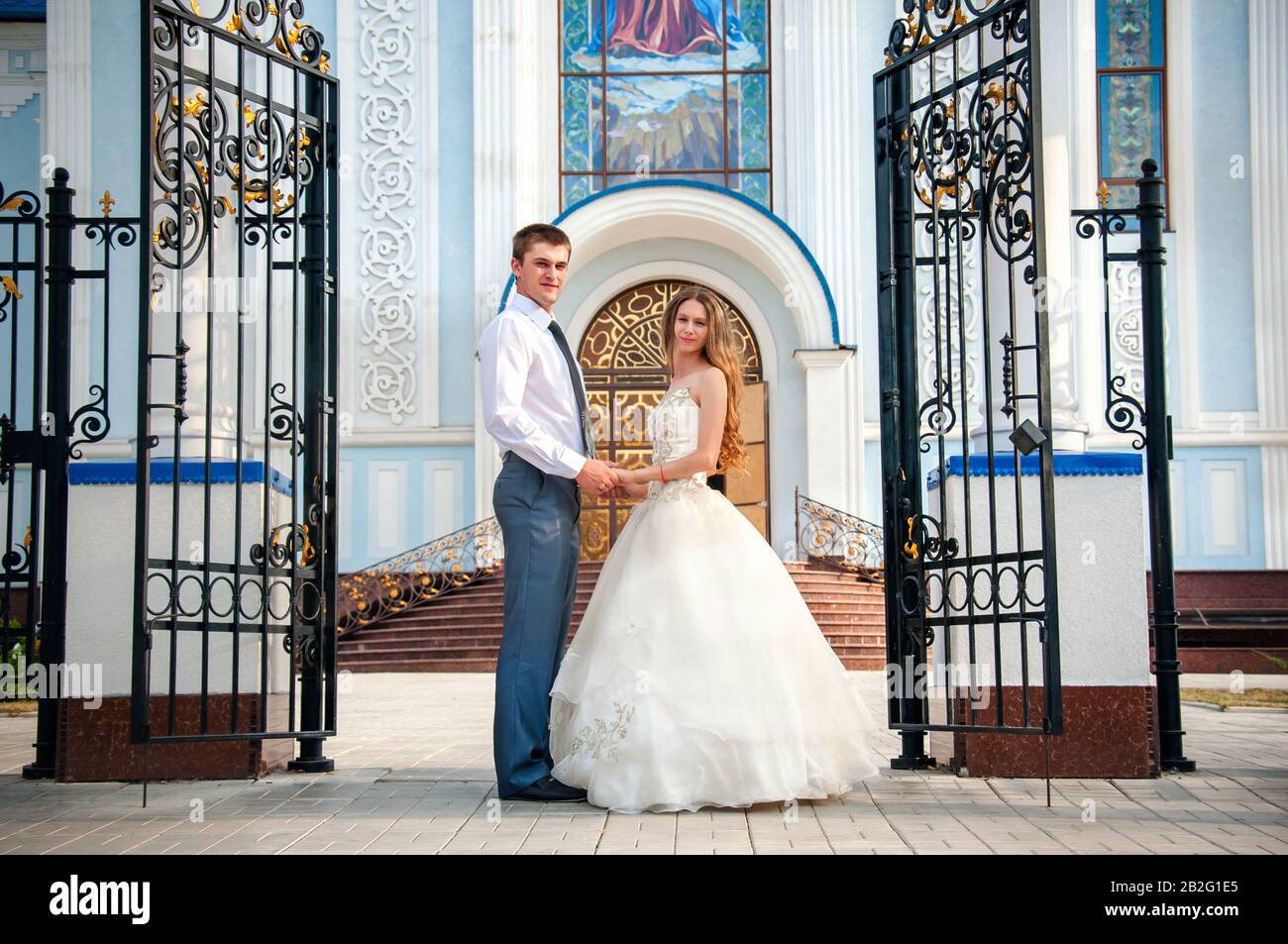 Wedding couple in front church hi-res stock photography and images - Alamy