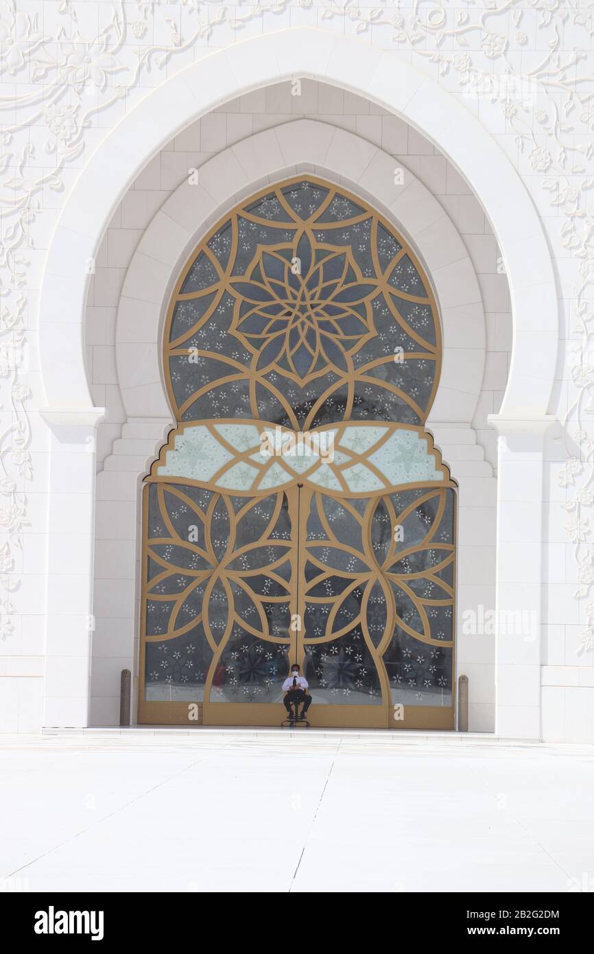 security guard at grand mosque wearing face mask to protect from covid-19 Stock Photo
