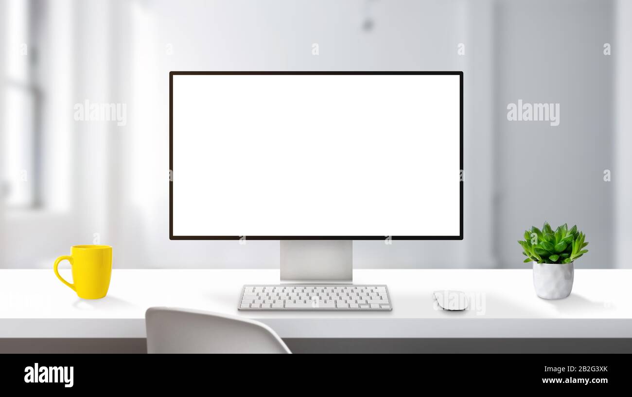 Modern computer display mockup on work desk with thin edges ...