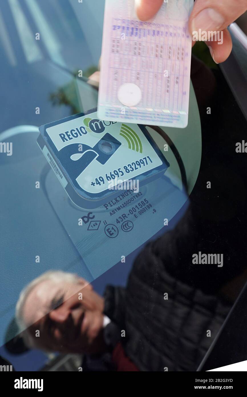 Maisborn, Germany. 02nd Mar, 2020. Reinhold Lauderbach unlocks the electric village car with an RFID chip that he has stuck on the back of his driver's license. Three months after the start of the project, the Rhine-Hunsrück district draws a positive interim balance: more trips are booked than once predicted by car sharing companies. Credit: Thomas Frey/dpa/Alamy Live News Stock Photo