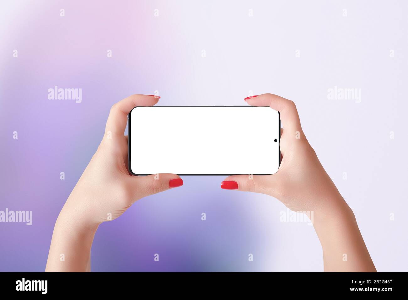 Phone mockup in horizontal position in woman hands. Purple abstract background Stock Photo