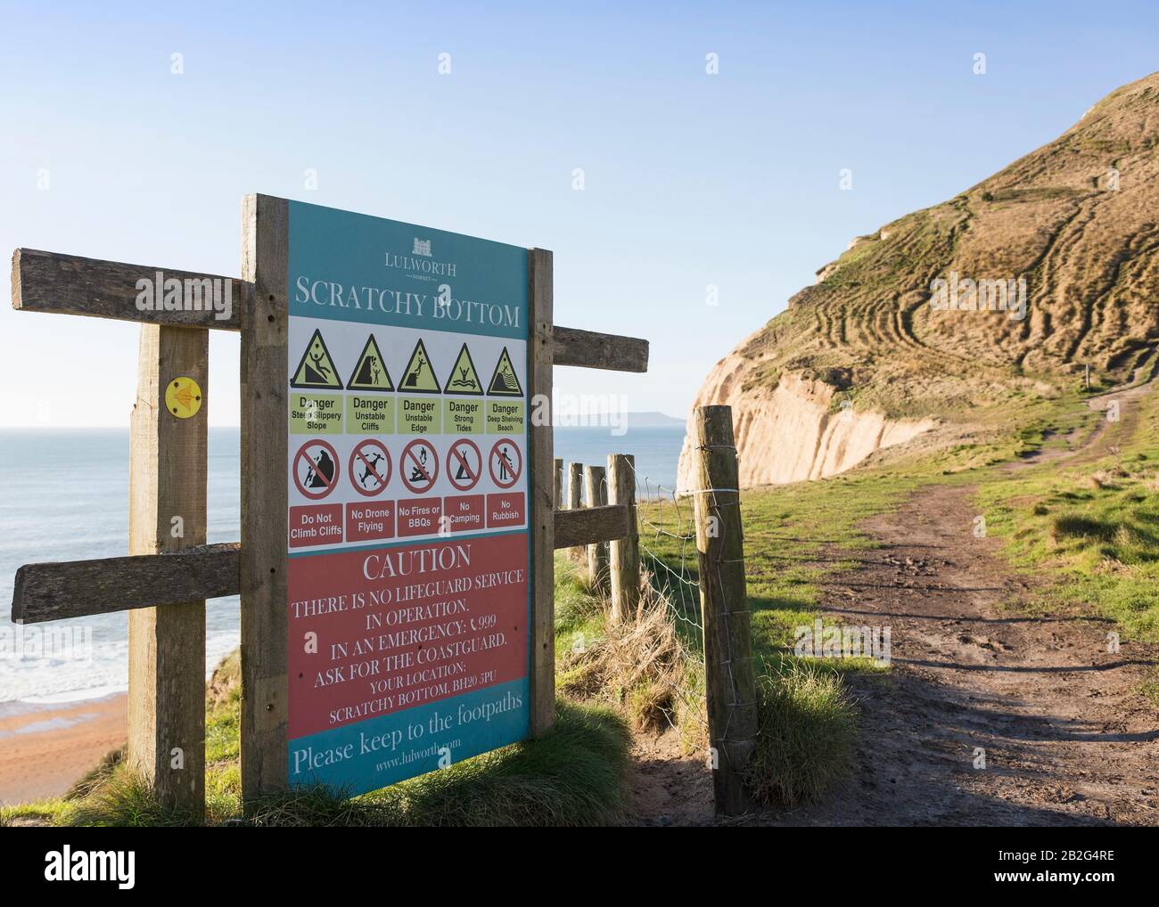 Warning sign at Scratchy Bottom, South West Coast Path, Dorset, England, UK Stock Photo