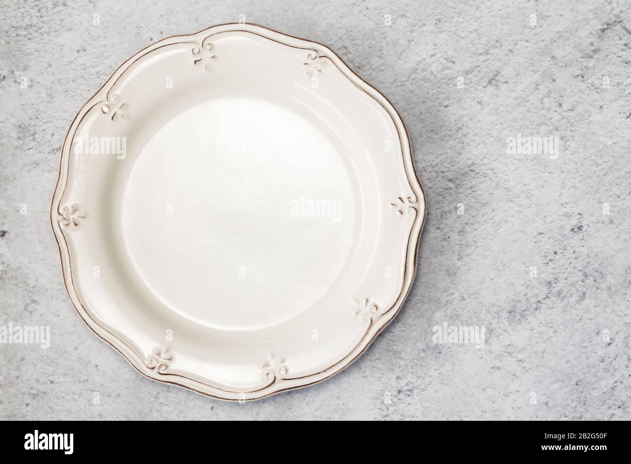 Empty plate fork and knife on table. Stock Photo