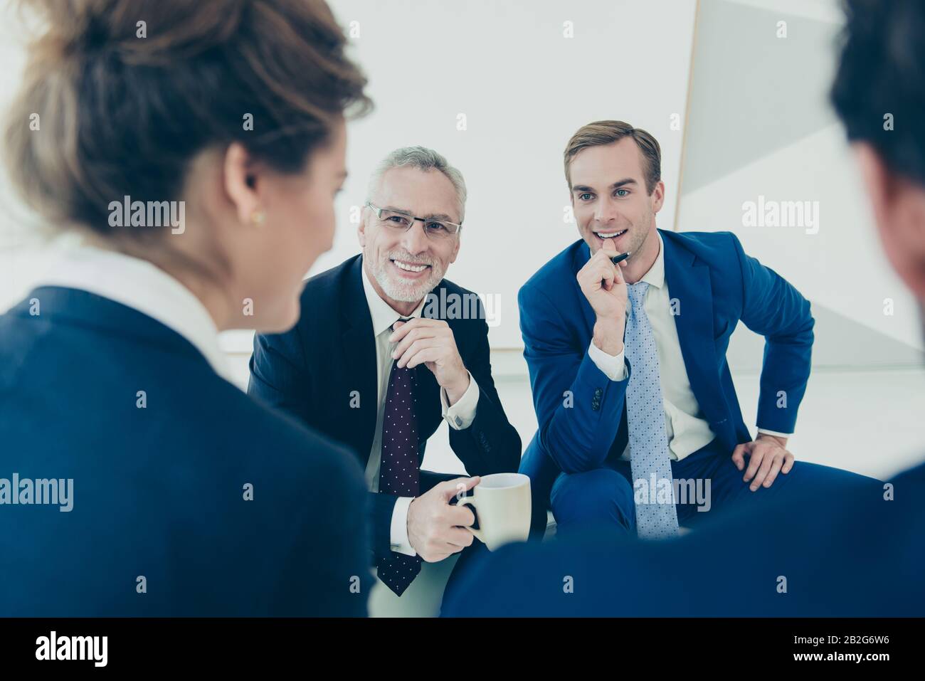 Portrait of two executive managers listening report on business meeting ...