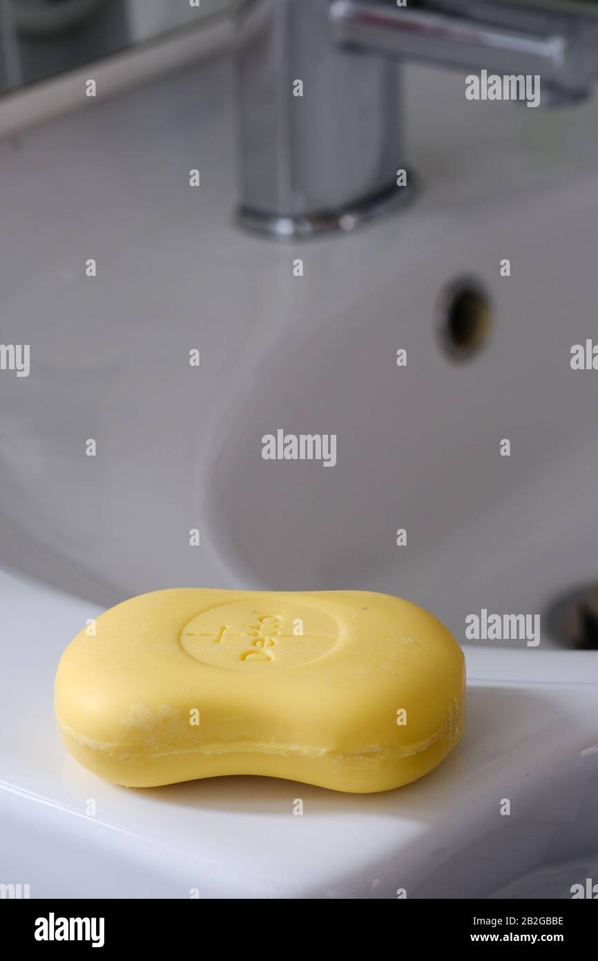 Bar of soap on the edge of a bathroom sink Stock Photo