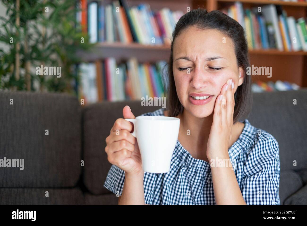 Woman suffering toothache because hot drink Stock Photo Alamy