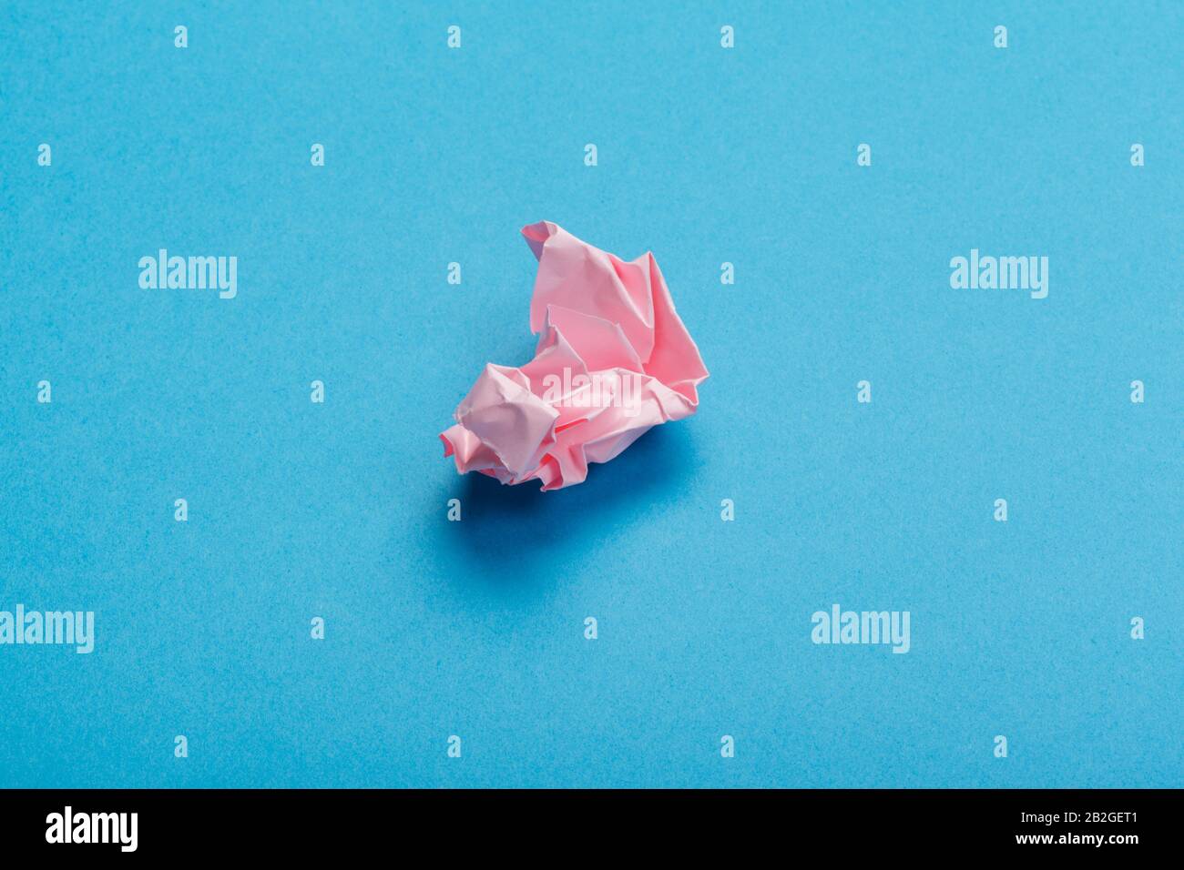 Wadded paper balls on a blue background Stock Photo