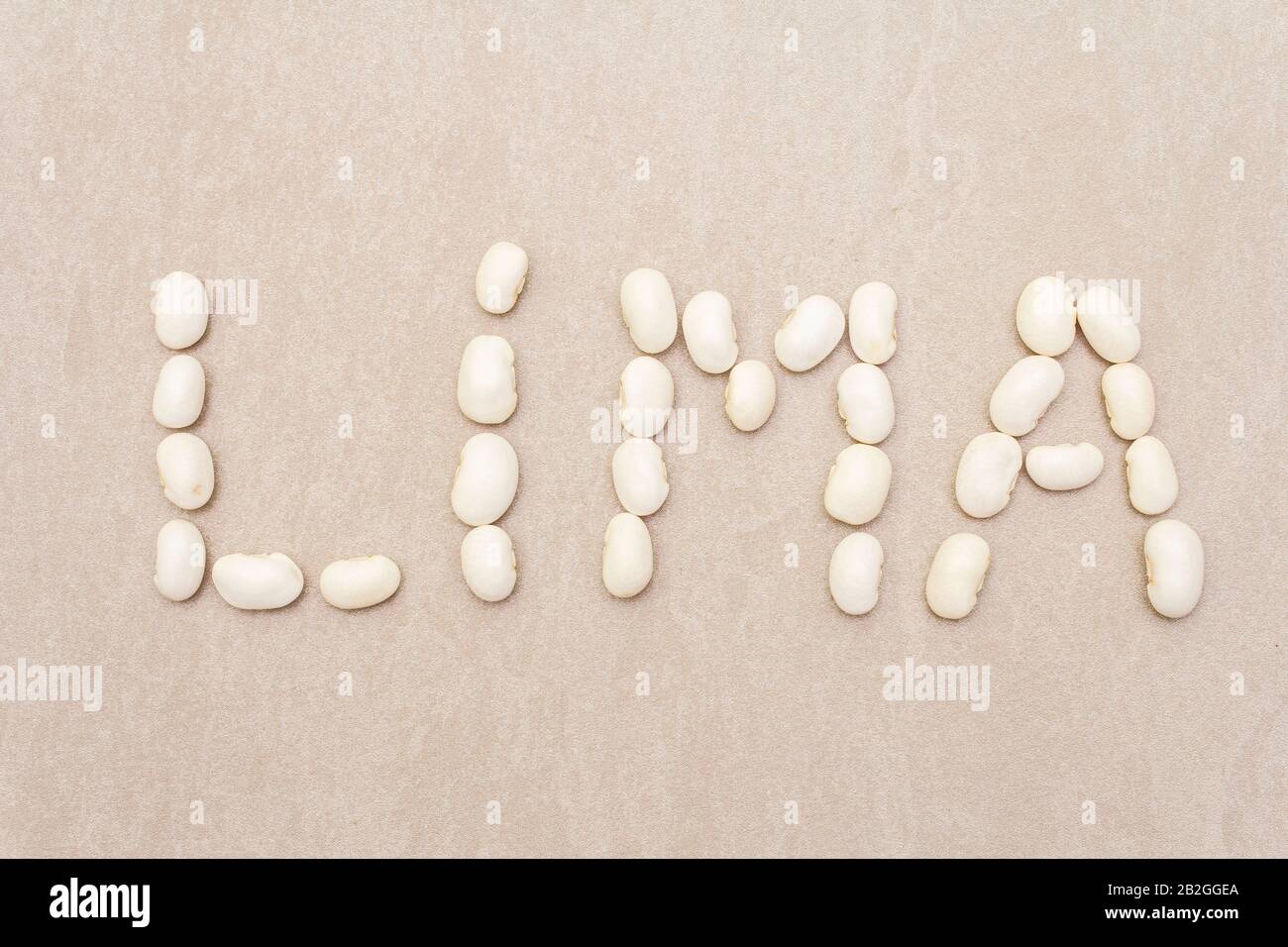 Lima symbols as letters made with lima beans on stone background as a