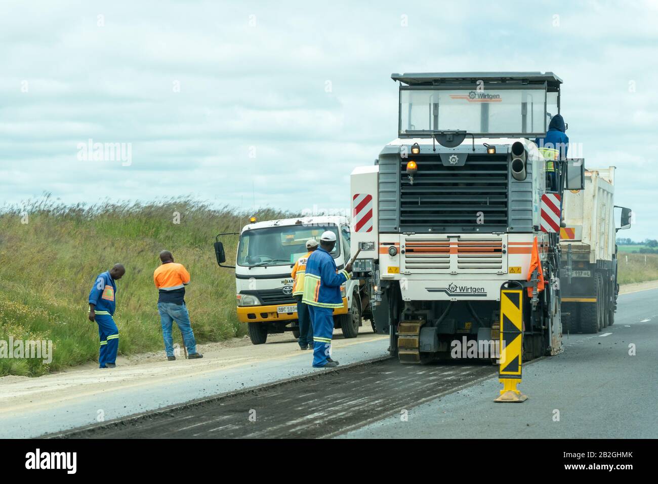 African men working on resurfacing and tarring a national road during roadworks in Gauteng province, South Africa Stock Photo