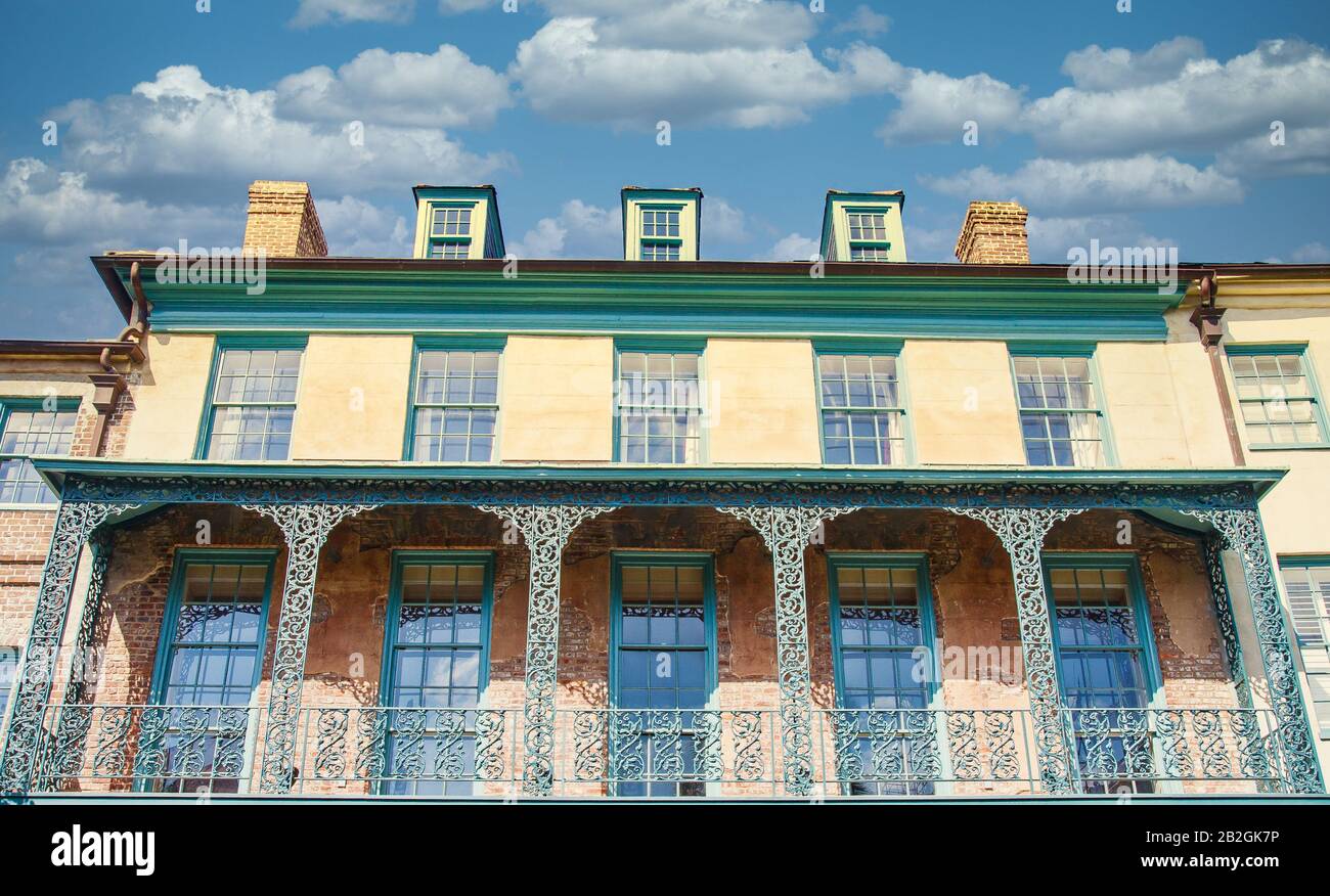 Old Iron Balconies on Yellow and Green Building Stock Photo