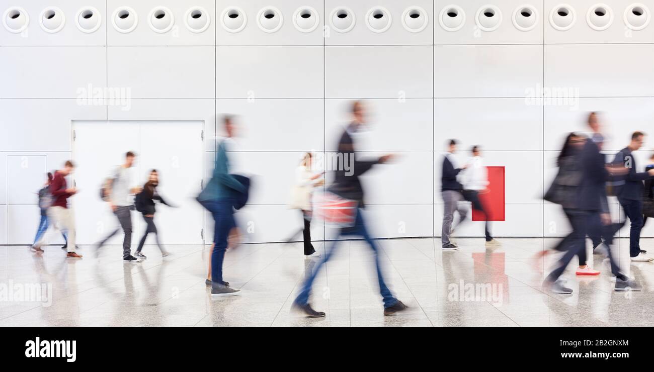 Many anonymous blurred people go shopping in the mall or airport Stock Photo