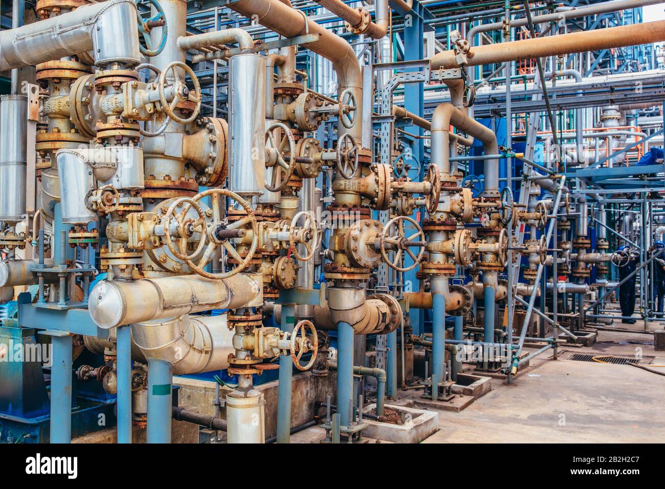 Industrial zone,The equipment of oil refining,Close-up of industrial pipelines of an oil-refinery plant,Detail of oil pipeline with valves in large oi Stock Photo