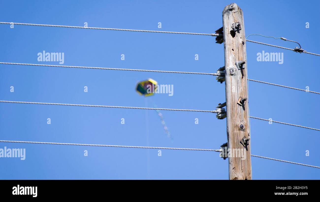 Dangerous flying of a kite near electric power transmission lines Stock Photo