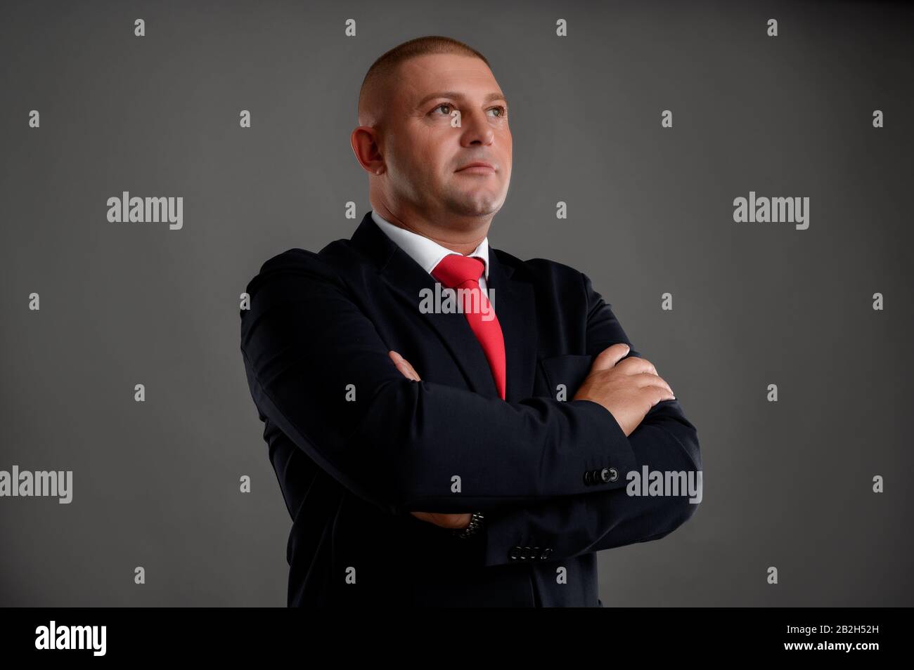 Businessman dressed in black suit showing confidence heor shot Stock ...